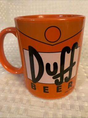 The Simpsons Orange Duff Beer Ceramic Mug, approximately 4 inches high. 2019.